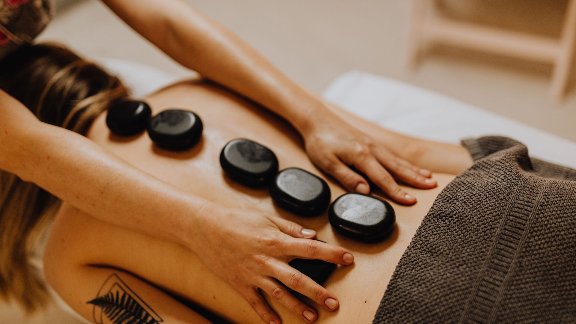 A woman getting a back massage at a spa