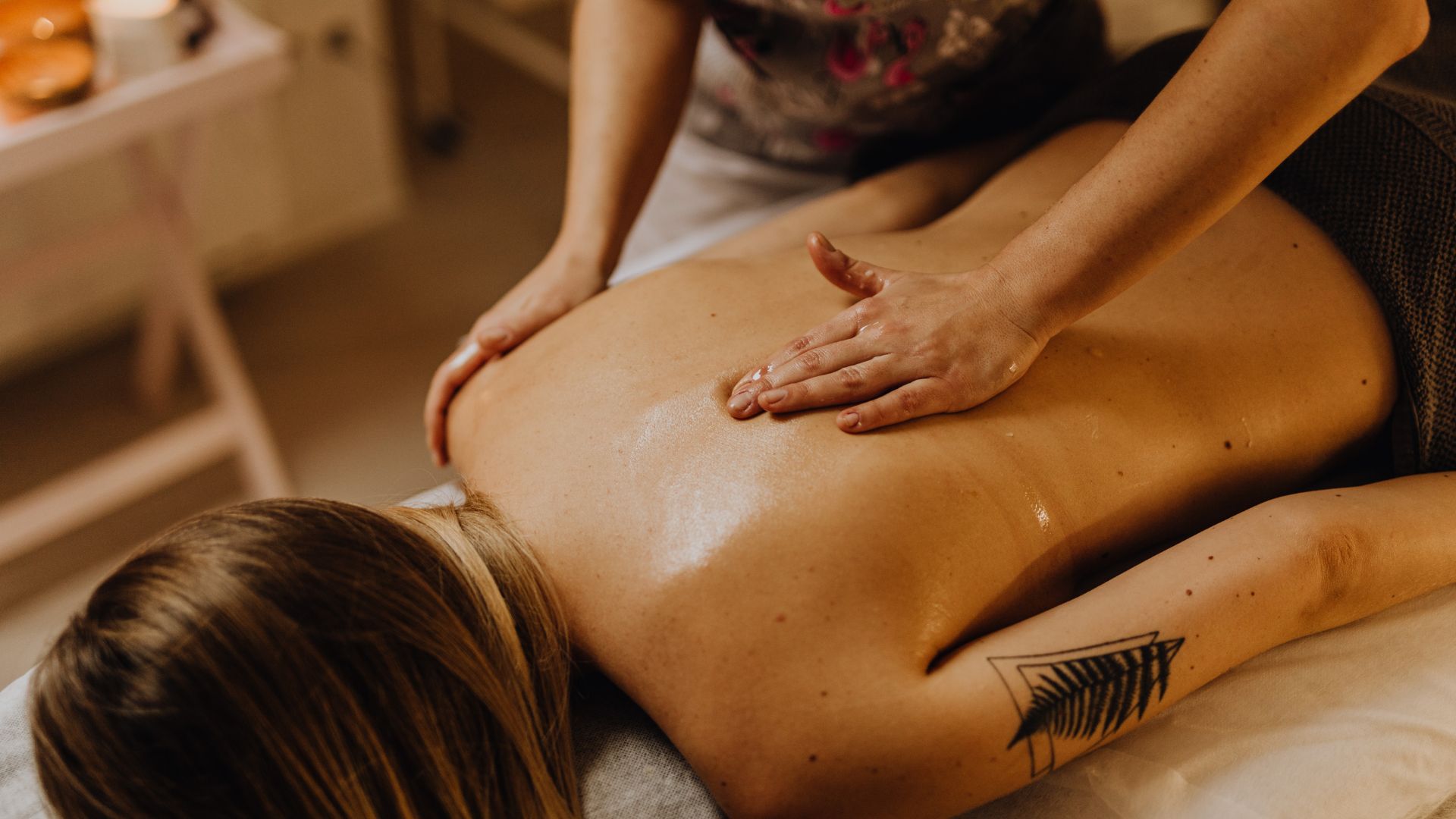 A woman getting a back massage at a spa