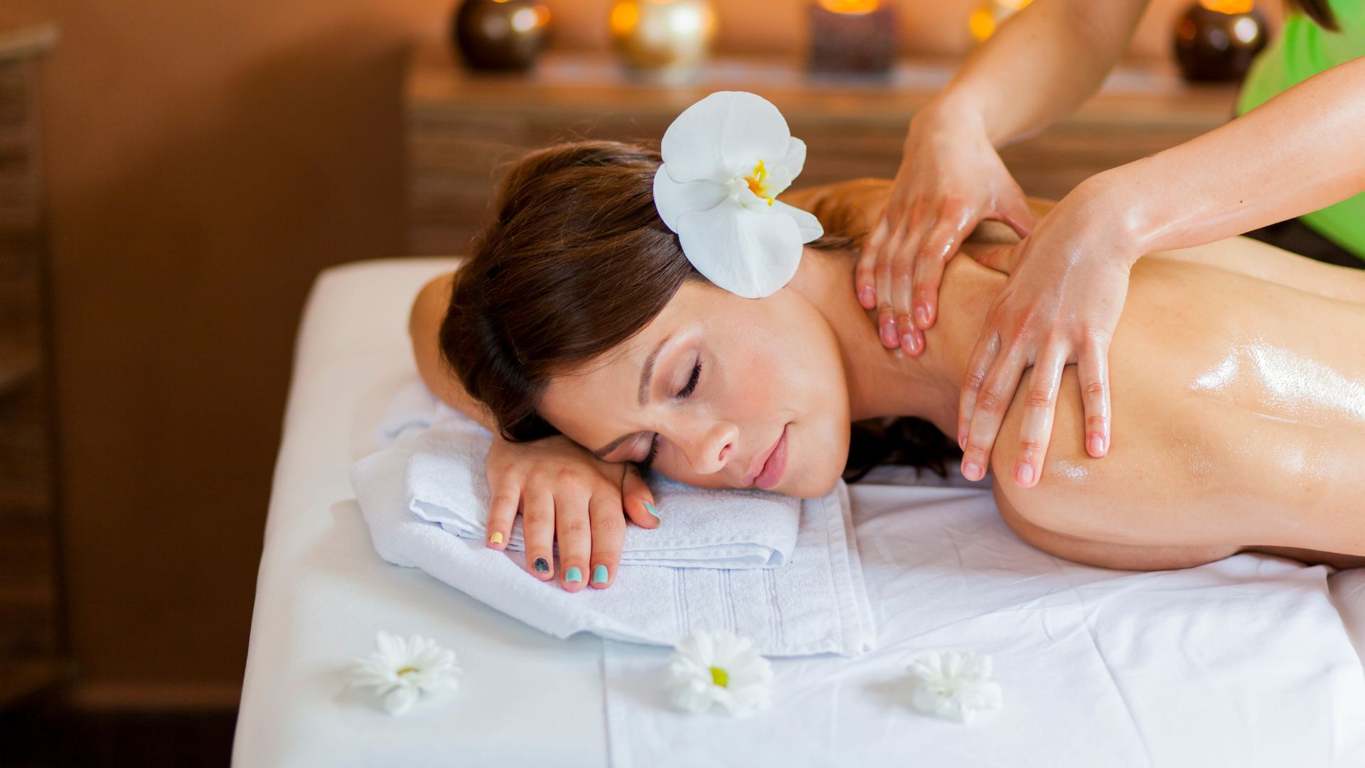 A woman getting a back massage at a spa